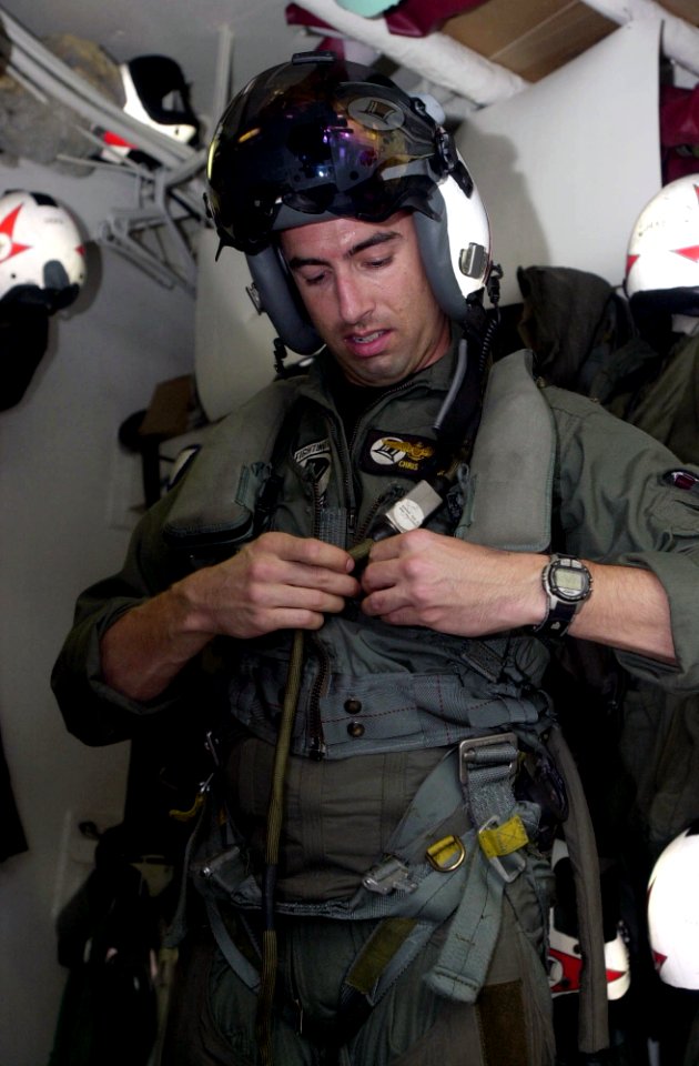 US Navy 030617-N-2385R-002 Lt. Christopher Papaioanu removes his flight gear in the paraloft aboard USS Nimitz (CVN 68)