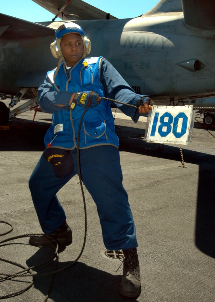 US Navy 030522-N-5786V-502 Airman Shamari Green from Brooklyn, N.Y., steadies a phone and distance line during an underway replenishment (UNREP) between the fast combat support ship USNS Arctic (T-AOE 8) and the Theodore Roosev