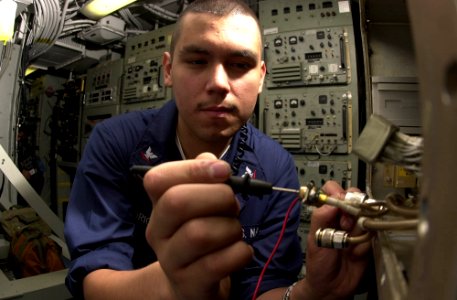 US Navy 030503-N-2143T-004 Electronics Technician 3rd Class Miguel Rodriguez of Los Angles, Calif., takes resistance checks aboard USS Nimitz (CVN 68)