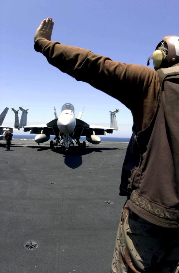 US Navy 030526-N-2385R-002 A plane captain begins start-up procedures on an F-A-18 Super Hornet prior to the first launch