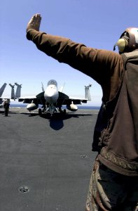 US Navy 030526-N-2385R-002 A plane captain begins start-up procedures on an F-A-18 Super Hornet prior to the first launch