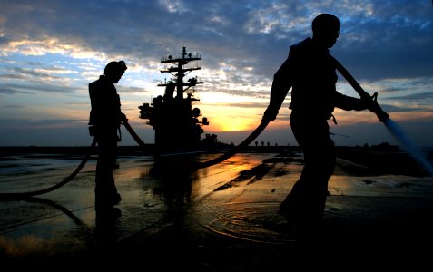 US Navy 030507-N-0696M-110 Aviation Boatswain's Mates wash down the ship's flight deck aboard PCU Ronald Reagan following a test of damage control systems