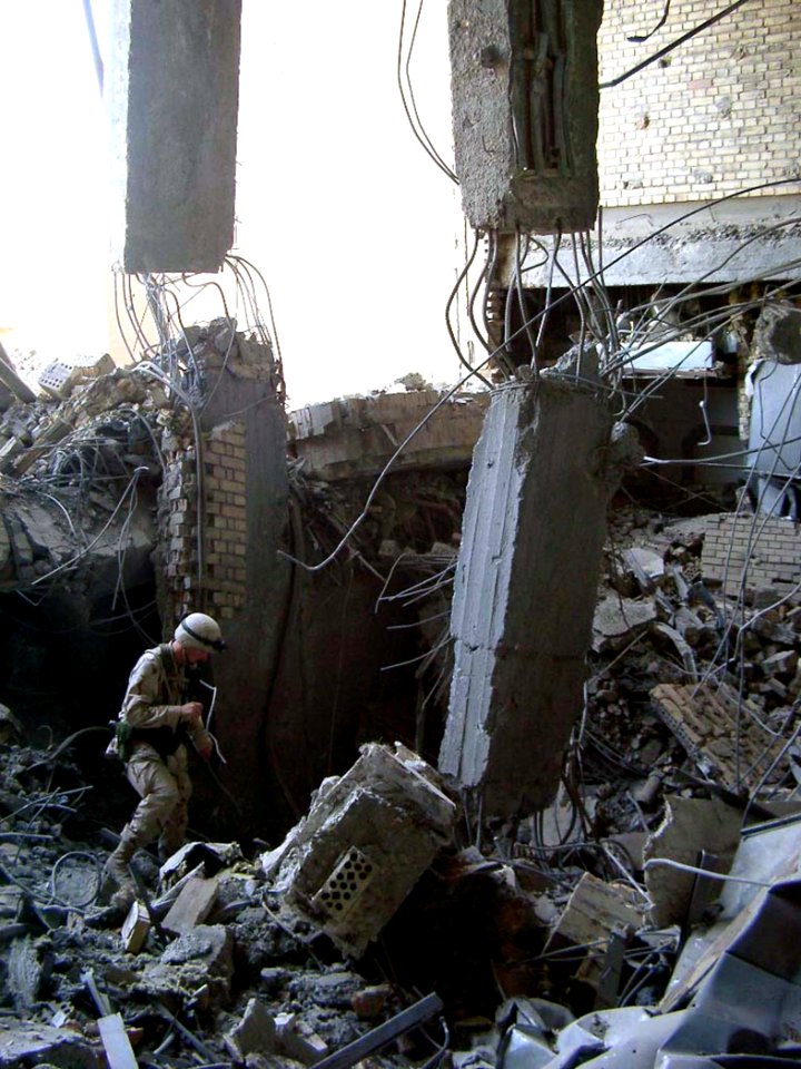 US Navy 030622-F-0000L-001 U.S. Navy Lt. Cmdr. Leonard Yowell examines the effectiveness of a Joint Direct Attack Munition (JDAM) at one of Saddam Hussein's presidential palaces