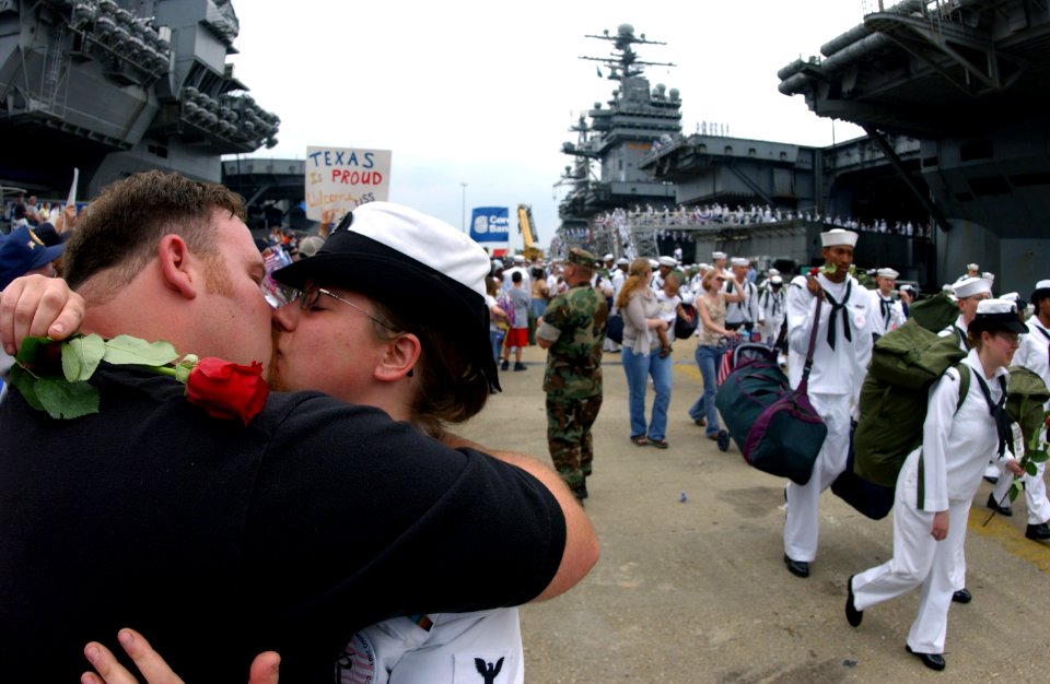 US Navy 030529-N-0696M-096 Aviation Machinist's Mate 3rd Class Aubry Cain is welcomed home by her husband as more Sailors from USS Theodore Roosevelt (CVN 71) search for their friends and family