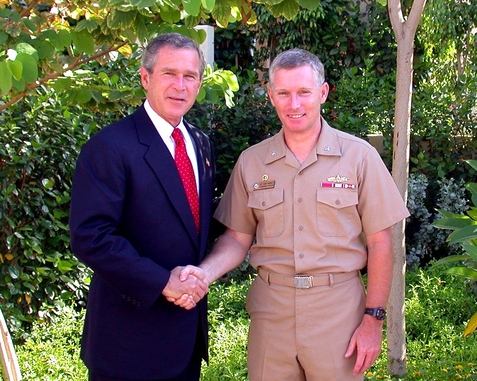 US Navy 030605-N-0000X-001 President George W. Bush congratulates Capt. Terence E. McKnight, Commanding Officer of the amphibious assault ship USS Kearsarge (LHD 3) for the support received from the officers and crew of the amp