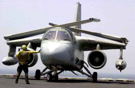 US Navy 030625-N-2385R-001 A flight deck handler directs an S-3B Viking onto one of the four steam powered catapults on the flight deck aboard USS Nimitz (CVN 68)