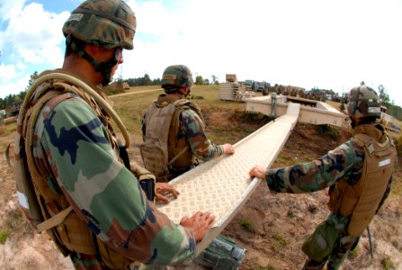 US Navy 081114-N-7367K-031 Seabees work together to launch a medium girder bridge