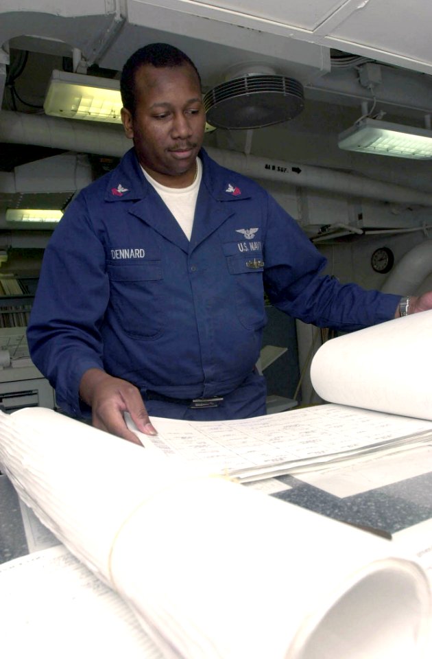 US Navy 030630-N-1577S-001 Aviation Boatswain's Mate 2nd Class Leemarr Dennard helps a customer with technical publications aboard USS Nimitz (CVN 68)
