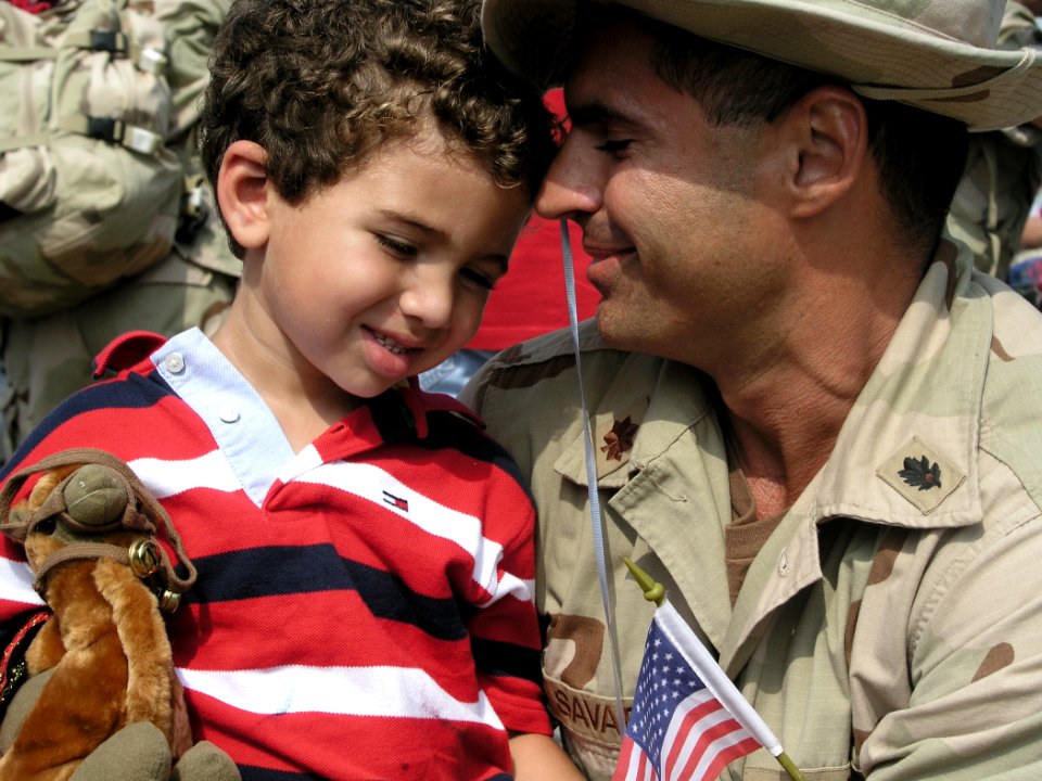 US Navy 030609-N-0728B-001 Lt. Cmdr. Richard Savarino shares a joyous moment of reunion with his son shortly after personnel from Fleet Hospital Three (FH-3) returned to Naval Hospital Pensacola from deployment in support of Op