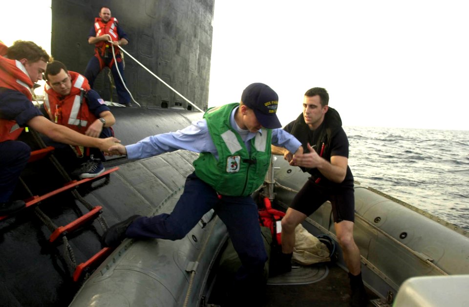 US Navy 030604-N-2385R-008 Boatswain's Mate 2nd Class Casey Opdahl helps an emergency medical patient onto the rigid hull inflatable boat (RHIB) from the attack submarine USS Pasadena (SSN 752)