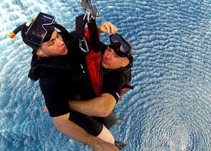 US Navy 030425-N-2819P-063 Aviation Machinist's Mate 2nd Class Joseph B. Harris (left) and Electronics Technician 2nd Class Chad Black, are hoisted upward to the CH-46 Sea Knight helicopter, as part of a sea