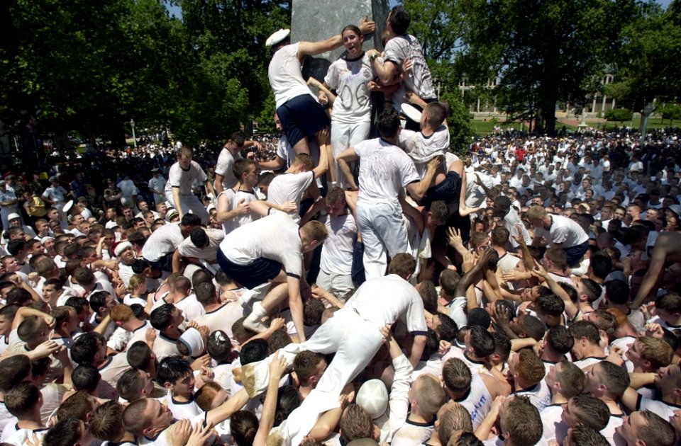 US Navy 030519-N-5319A-010 United States Naval Academy Freshman attempt climbing the Herndon Monument, a 21-foot gray obelisk covered in more than 200 pounds of lard, marking the end of their first year of training