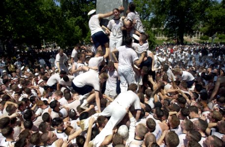 US Navy 030519-N-5319A-010 United States Naval Academy Freshman attempt climbing the Herndon Monument, a 21-foot gray obelisk covered in more than 200 pounds of lard, marking the end of their first year of training