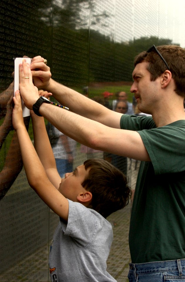 US Navy 030616-N-9593R-143 Visitors to the Vietnam Veterans Memorial Wall, take rubbings of the name, of a family member