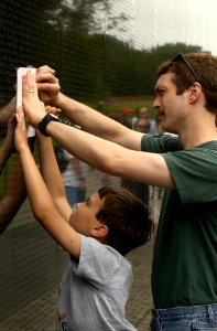 US Navy 030616-N-9593R-143 Visitors to the Vietnam Veterans Memorial Wall, take rubbings of the name, of a family member