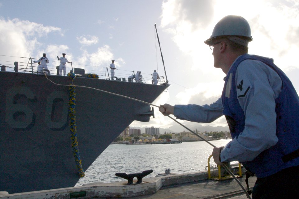 US Navy 030426-N-3228G-008 A Naval Station Pearl Harbor line-handler helps moor USS Paul Hamilton (DDG 60) during the ship's homecoming