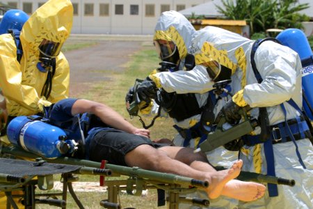 US Navy 030522-N-3228G-001 Members of the 93rd Weapons of Mass Destruction Civil Support Team (WMD CST) scan a survey team member for nerve or blister agents with chemical detection equipment during a casualty evacuation drill