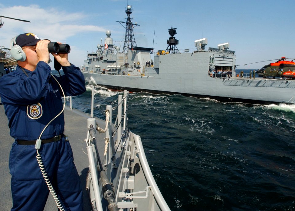 US Navy 030608-N-4374S-020 Operations Specialist 2nd Class Matthew Cooper, assigned to the Aegis cruiser USS Vella Gulf, stands aft lookout watch during a high-line transfer with the German Bremen class frigate FGS Lubeck (F 21