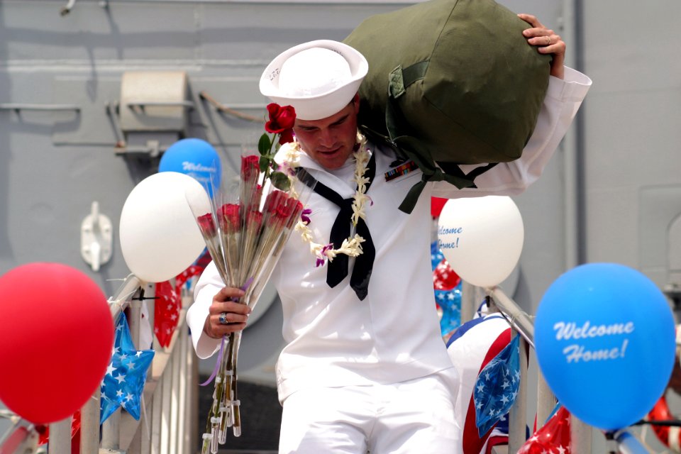 US Navy 030427-N-3228G-002 A Sailor rushes down the brow of Oliver Hazard Perry-class guided missile frigate USS Reuben James (FFG 57) to meet family members shortly after returning to homeport
