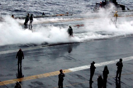 US Navy 090916-N-8960W-175 Sailors aboard the aircraft carrier USS Nimitz (CVN 68) recover the flight deck after launching alert aircraft photo