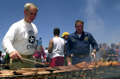 US Navy 030501-N-1577S-002 Capt. Robert Gilman and Capt. William Cone, Commanding and Executive Officer of the aircraft carrier USS Nimitz (CVN 68) prepare food for the crew during a steel beach picnic