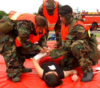 US Navy 030604-N-0000W-001 Members of Yokosuka's Special Medical Operations Response Team assist a simulated casualty during a helicopter crash training exercise