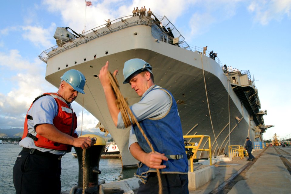 US Navy 030702-N-3228G-001 Sailors secure the forward mooring line for the amphibious assault ship USS Tarawa (LHA 1) as the ship begins a four-day port visit