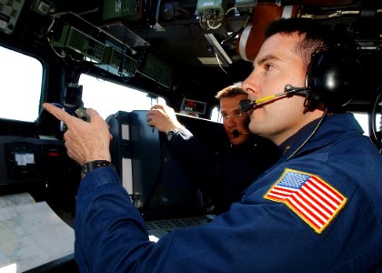 US Navy 030613-N-4374S-019 Lt. Cmdr. Ed Devinney, Executive Officer of the Aegis class, guided missile cruiser USS Vella Gulf (CG 72) is given a tour by the Lt. Cmdr. Jon Wikingsson, Executive Officer of the Swedish fast patrol