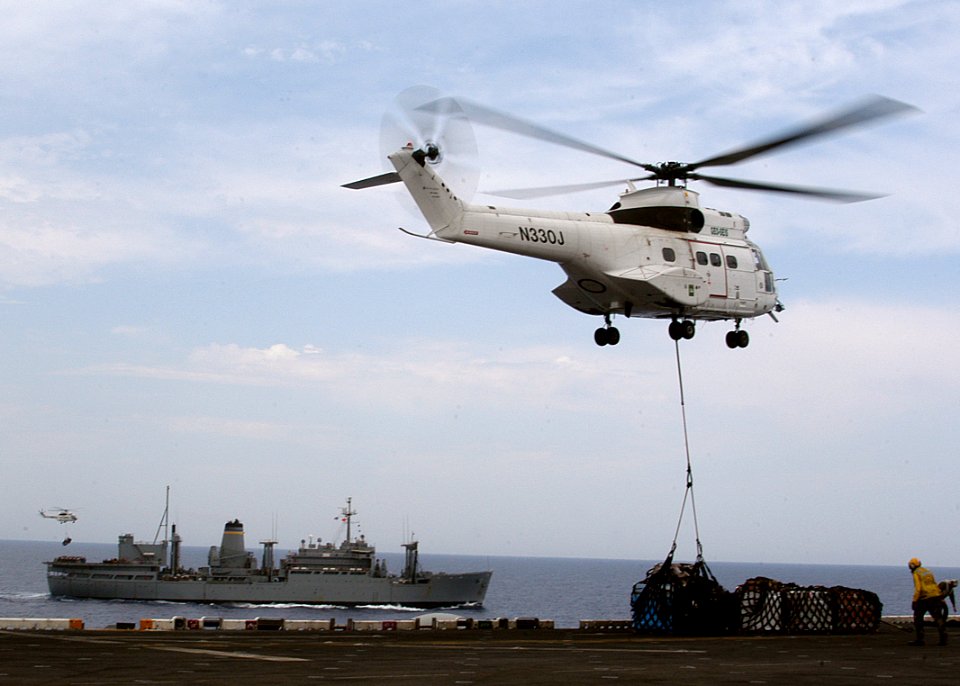 US Navy 030607-N-2819P-007 SA-332 Super Puma helicopters from Military Sealift Command combat stores ship USNS Spica (T-AFS 9) delivers pallets of supplies to USS Kearsarge (LHD 3)