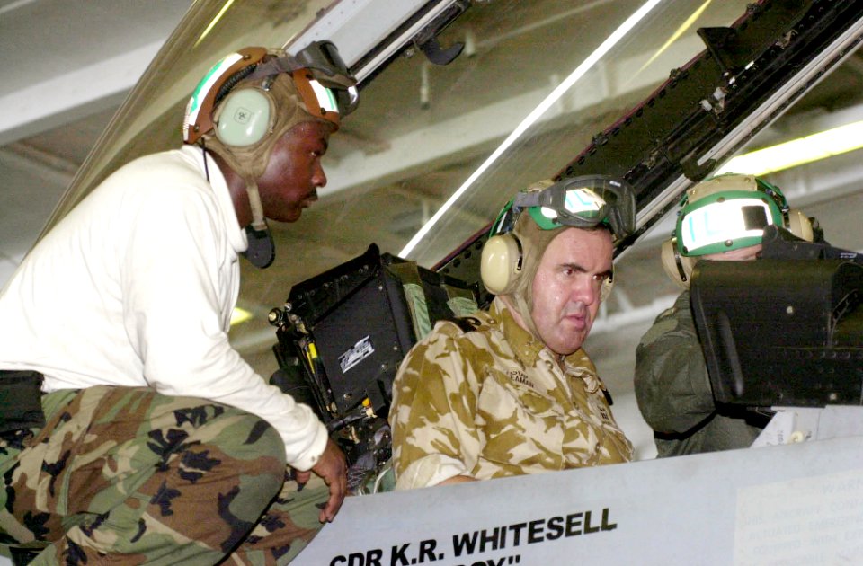 US Navy 030728-N-2143T-001 British Royal Navy Commodore, Richard Leaman, receives a familiarization brief while seated in the cockpit of a F-A-18F Super Hornet