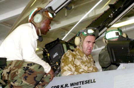 US Navy 030728-N-2143T-001 British Royal Navy Commodore, Richard Leaman, receives a familiarization brief while seated in the cockpit of a F-A-18F Super Hornet