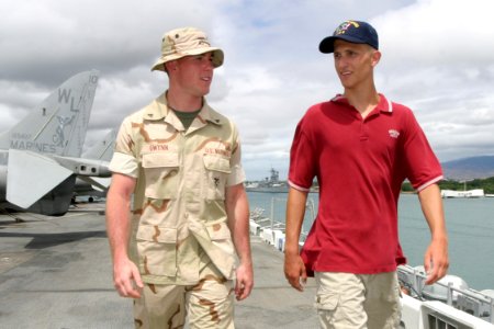 US Navy 030716-N-3228G-006 U.S. Marine Cpl. Quentin Gwynn, a support equipment technician aboard the amphibious assault ship USS Bonhomme Richard (LHD 6) gives a tour of the ship to 16 year-old Adam Smith
