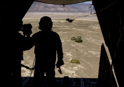 US Navy 030811-F-7823A-002 U.S. Air Force Pararescuemen from Moody Air Force Base Ga., prepare to parachute out of an HC-130 Talon II to secure a downed pilot