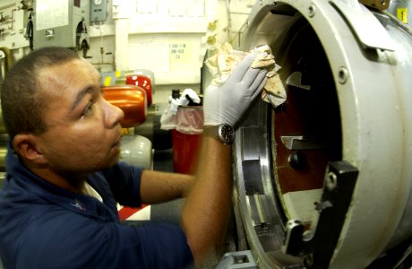 US Navy 030819-N-2613R-006 Torpedoman 3rd Class Jhonny Bardsley from Chicago, Ill., conducts quarterly maintenance on one of the ship's MK-32 Surface Vessel Torpedo Tubes