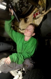 US Navy 030620-N-0413R-002 Aviation Machinist's Mate 3rd Class Elisabeth Medlin installs an engine in an F-A-18F Super Hornet in the Hanger Bay aboard USS Nimitz (CVN-68)
