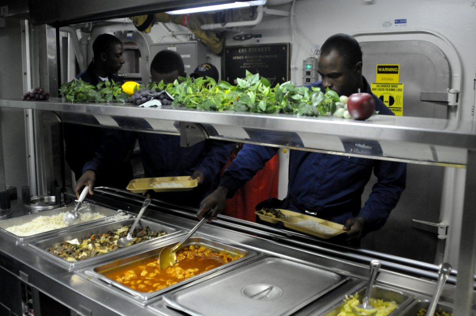 US Navy 100621-N-0775Y-079 Sailors pass through the mess line aboard USS Sterett (DDG 104)