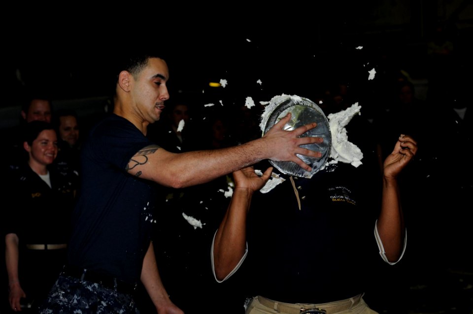 US Navy 100307-N-3592S-139 Culinary Specialist 3rd Class Bryant Alvarez puts a pie in the face of Chief Warrant Officer Bernice Williamson