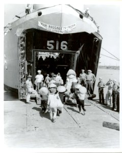US Navy 030630-N-0000X-001 Vietnamese refugees board LST 516 for their journey from Haiphong, North Vietnam, to Saigon, South Vietnam during Operation Passage to Freedom, October 1954