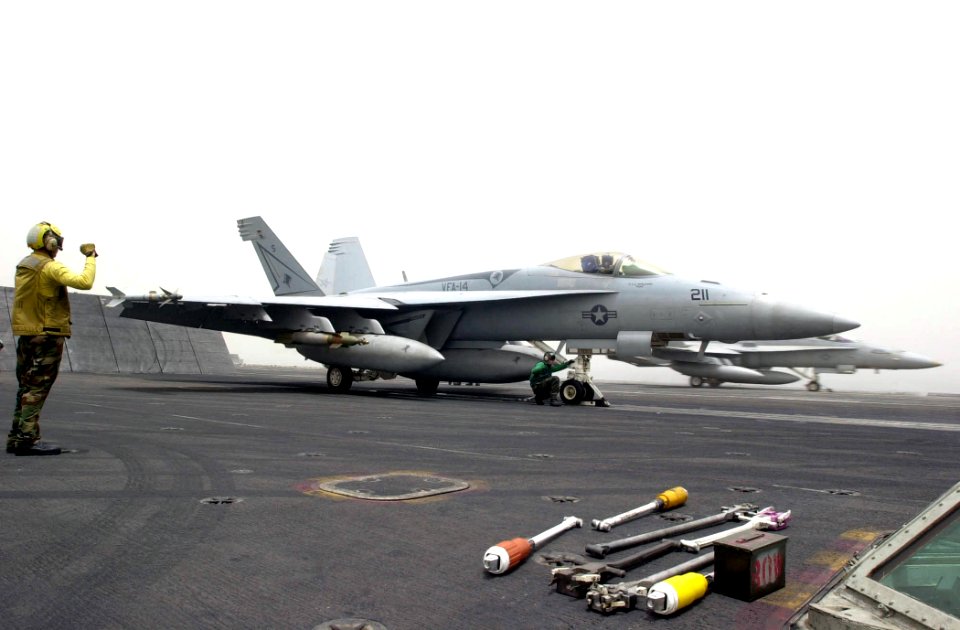 US Navy 030517-N-2385R-003 An F-A-18E Hornet, assigned to the Tophatters of Strike Fighter Squadron One Four (VFA-14), prepares to launch from one of four steam-driven catapults aboard the nuclear powered aircraft carrier USS N