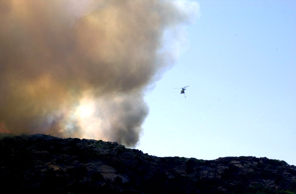 US Navy 030708-N-0000X-001 An Italian Helicopter assists in U.S. Navy fire fighting efforts on the island of Santo Stefano