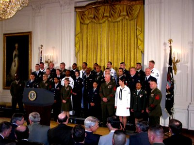US Navy 030701-A-0000S-001 hirty service members representing each branch of the military, to include the U.S. Coast Guard, await President Bush's arrival