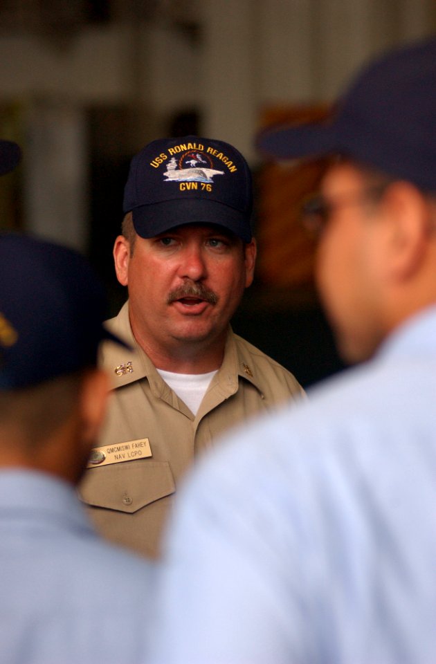 US Navy 030707-N-0696M-013 Master Chief Quartermaster Lawrence Fahey gives instructions to the side boys that will welcome platform guests aboard the Navy's newest aircraft carrier during the commissioning ceremony scheduled fo
