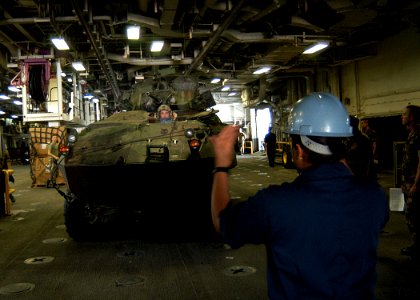 US Navy 030628-N-2972R-091 Seaman Apprentice Johanna Cochrane directs a U.S. Marine Corps Light Armored Vehicle (LAV) during a off load of the Second Marine Expeditionary Brigade