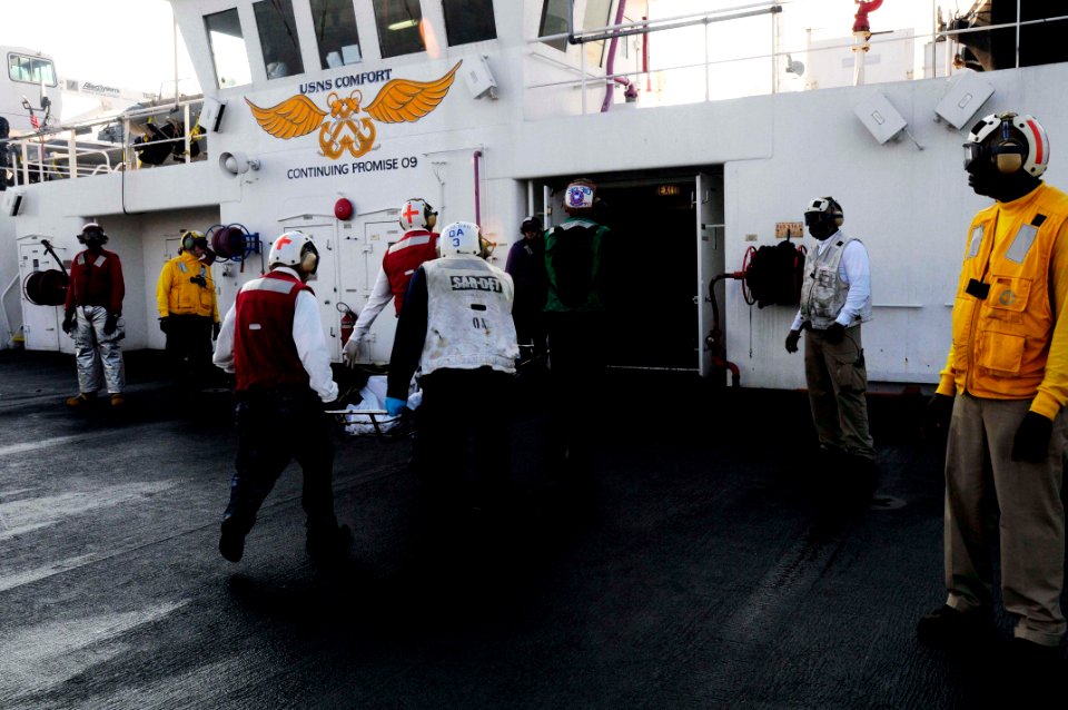 US Navy 100120-N-4378P-089 USNS Comfort (T-AH 20) receive a patient from USS Carl Vinson (CVN 70)
