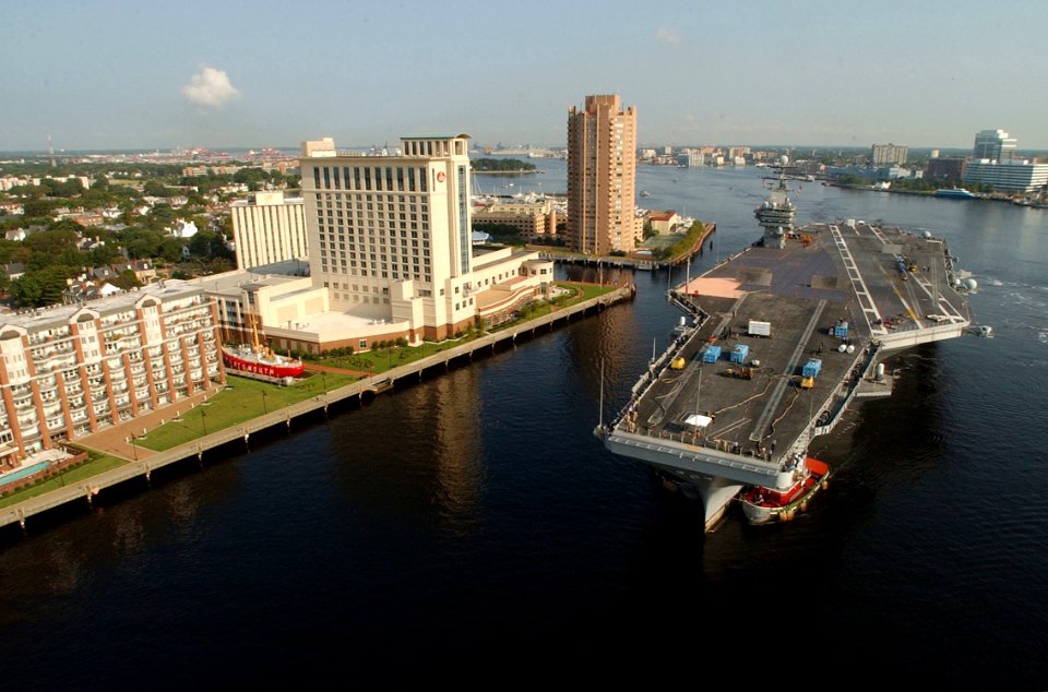 US Navy 030820-N-9851B-053 Tug boats guide USS Harry S. Truman (CVN 75) up the Elizabeth River, past Portsmouth landmarks, to the Norfolk Naval Shipyard