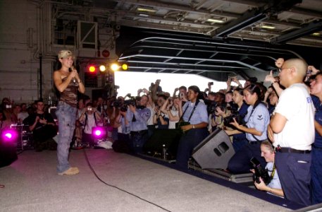 US Navy 030619-N-2143T-003 Actress Alyssa Milano speaks to sailors at the United Service Organization (USO) show during a visit aboard USS Nimitz (CVN 68)
