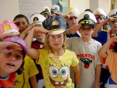 US Navy 030708-N-4775H-004 Participants at the Navy Museum's recent Children's Maritime Craft Day make snappy salutes while modeling their newly made versions, of the Navy's Combination Cover