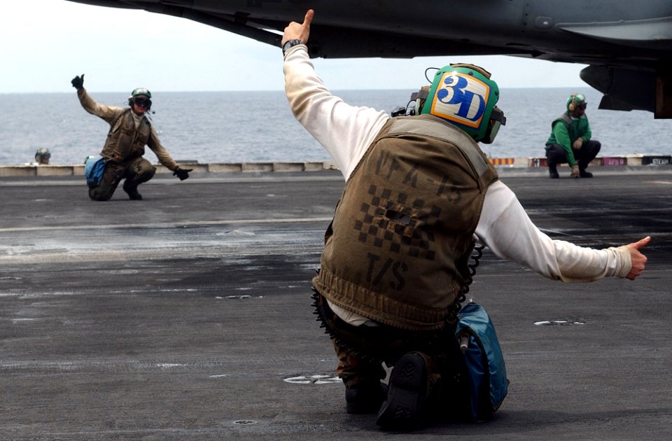 US Navy 030528-N-6141B-011 Final Checkers for the Valions of Strike Fighter Squadron Fifteen (VFA-15) give a thumbs up while preparing to launch