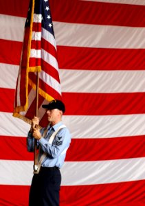US Navy 030709-N-0696M-008 Personnelman 1st Class William E. Evans carries the National Ensign during color guard rehearsals in preparation for the ship's commissioning ceremony, scheduled for July 12th, 2003