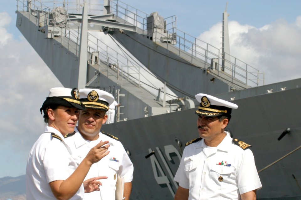 US Navy 030723-N-3228G-003 Lieutenant junior grade Erin Bailey discusses the port visit of Mexican Navy ship Usumacinta (A-412), formerly USS Frederick (LST-1184), with Mexican officers shortly after the ship's arrival in